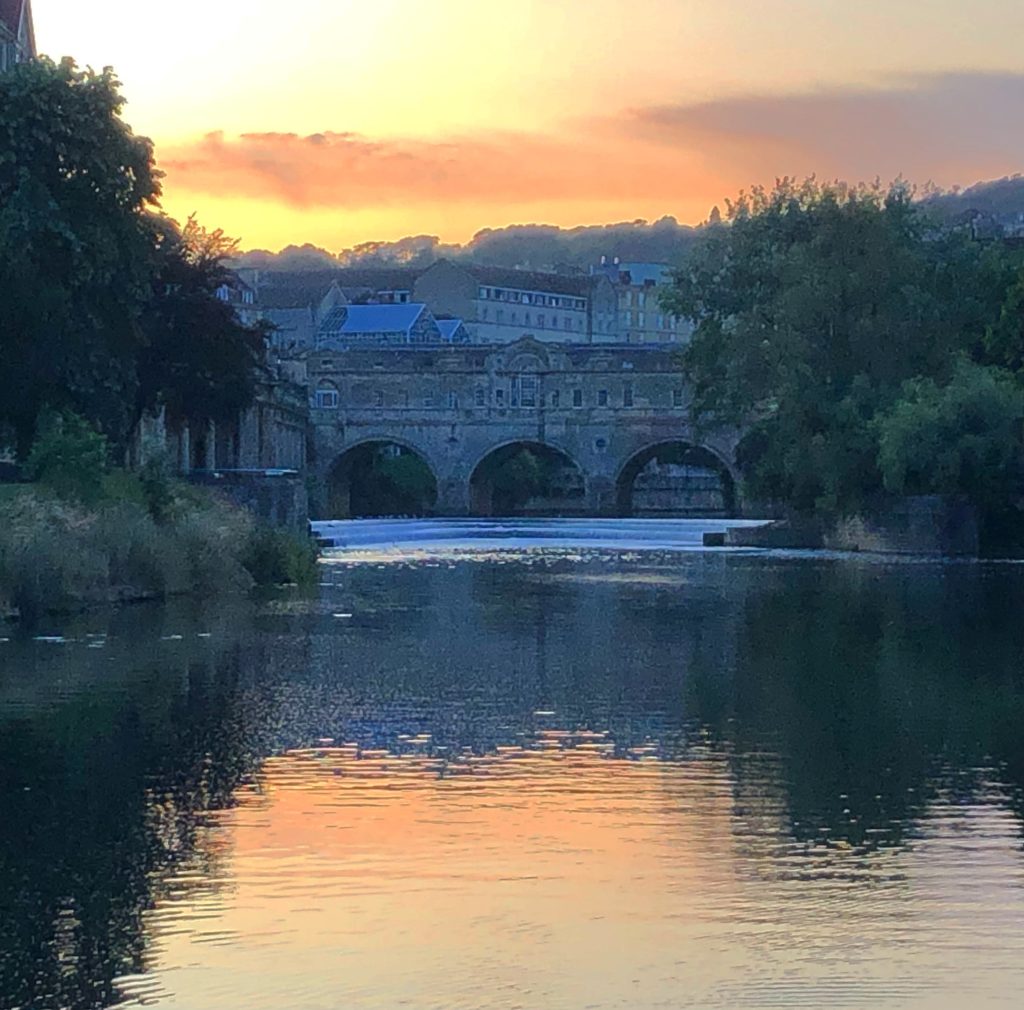 July 2019 - Pulteney Bridge at sunset with the River Avon in the foreground.