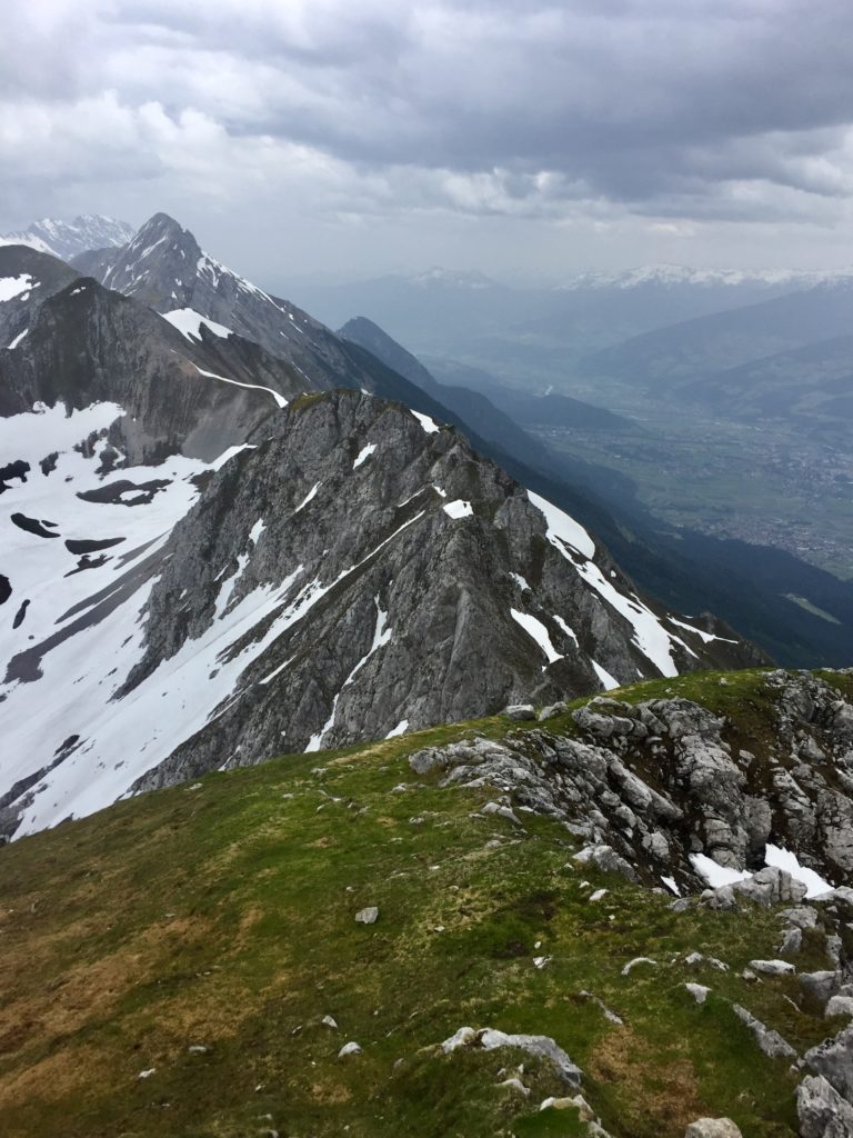 View across the Nordkette mountains, with Innsbruck to the right and snow on the left.