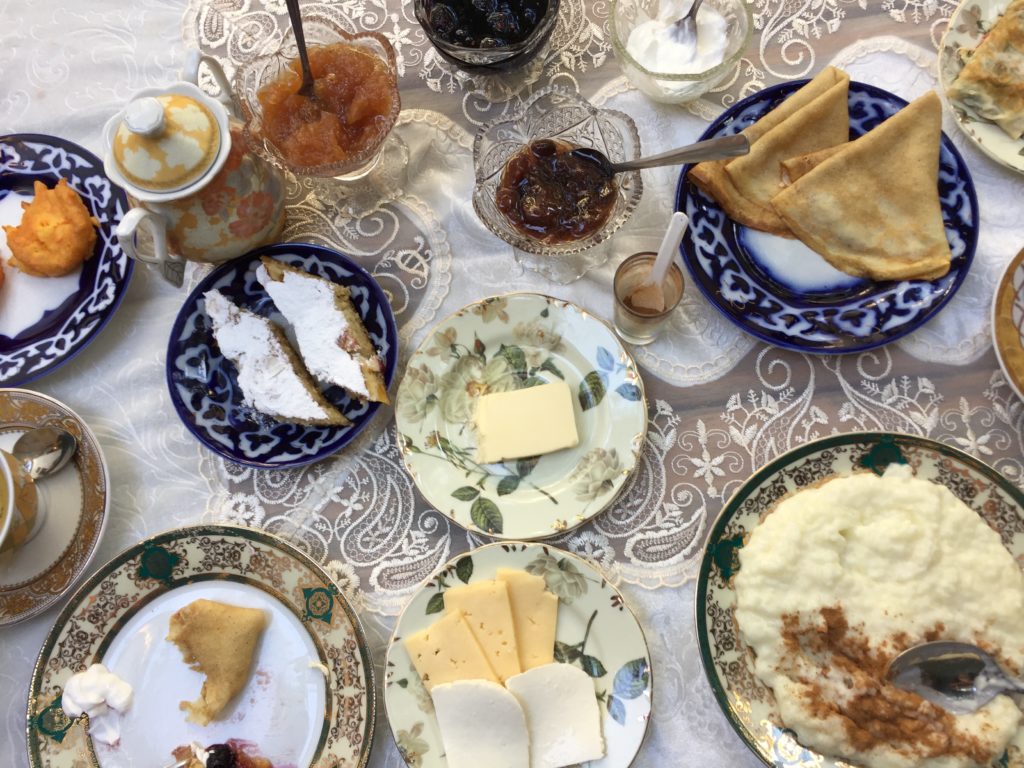 travel when not travelling - Uzbek breakfast - an array of small dishes with hot and cold food