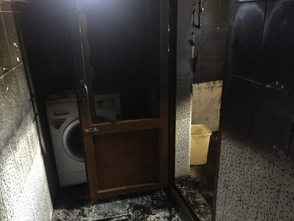 Fire in Samarkand - the hallway with dark water and black walls and the doorway where we saw flames coming from during our escape.