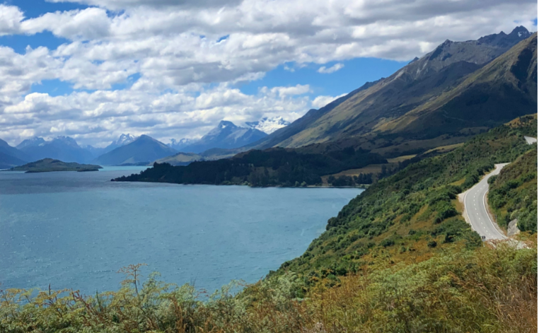 2019 review: a picture of a road running down the right hand side, with mountains in the background and a blue lake to the left.