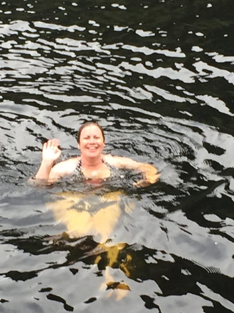 Doubtful Sound - a close up of me swimming and waving in the water.
