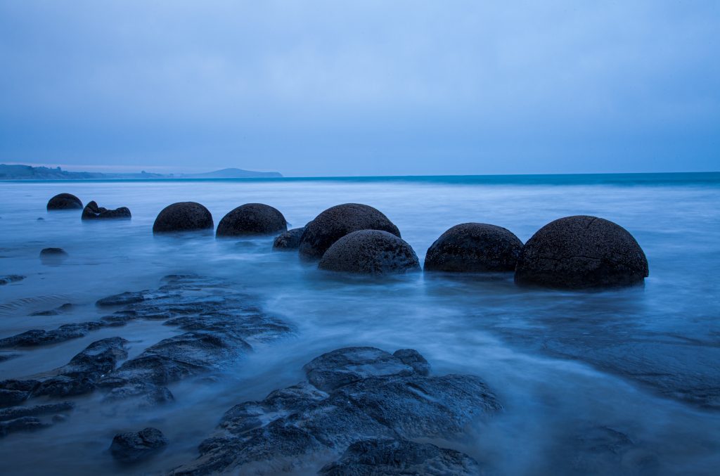 Moeraki Boulders on South Island. Round boulders (perfectly spherical) at high tide.