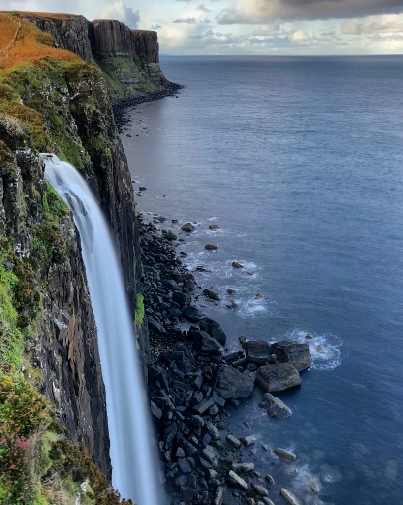 A waterfall plunging into the sea.